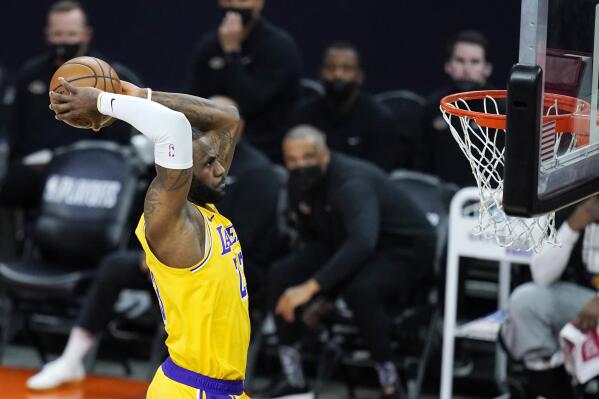 Los Angeles Lakers forward LeBron James goes in for a dunk against the Phoenix Suns during the first half of Game 2 of their NBA basketball first-round playoff series Tuesday, May 25, 2021, in Phoenix. (AP Photo/Ross D. Franklin)