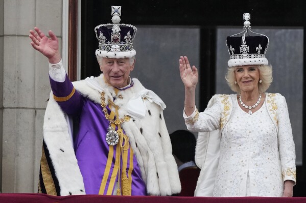 Britain's King Charles III and Queen Camilla wave to the crowds from the balcony of Buckingham Palace after the coronation ceremony in London, May 6, 2023. (AP Photo/Frank Augstein)