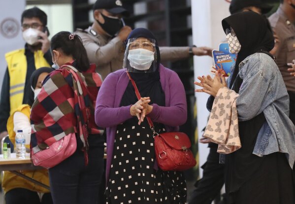 Relatives of passengers arrive at a crisis center set up following a report that a Sriwijaya Air passenger jet has lost contact with air traffic controllers shortly after take off, at Soekarno-Hatta International Airport in Tangerang, Indonesia,Saturday, Jan. 9, 2021. The Boeing 737-500 took off from Jakarta and lost contact with the control tower a few moments later. (AP Photo/Tatan Syuflana)