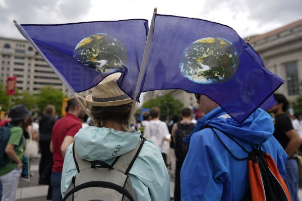 FILE - Climate activists hold a rally to protest the use of fossil fuels on Earth Day at Freedom Plaza, April 22, 2023, in Washington. (AP Photo/Carolyn Kaster, File)
