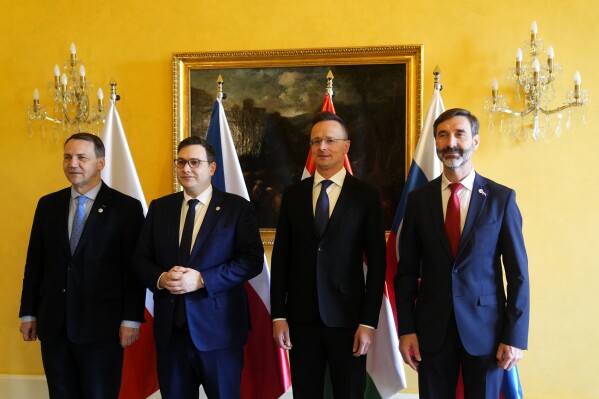 Czech Republic's Foreign Minister Jan Lipavsky, 2nd left, welcomes his counterparts from Poland Radoslaw Sikorski, left, from Slovakia Juraj Blanar, right, and Hungary Peter Szijjarto, second right, as they meet in Prague, Czech Republic, Thursday, March 21, 2024. (AP Photo/Petr David Josek)