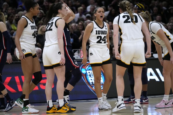 Iowa guard Gabbie Marshall (24) celebrates with teammates during the second half of a Final Four college basketball game against UConn in the women's NCAA Tournament, Friday, April 5, 2024, in Cleveland. Iowa won 71-69. (AP Photo/Carolyn Kaster)