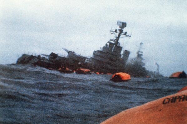 FILE - The Argentinian cruiser General Belgrano sinks amid orange life rafts holding survivors in the South Atlantic Ocean, May 1, 1982, after being torpedoed by the British Royal Navy. The government of Argentina informed Britain on Thursday, March 2, 2023, that it has ended a cooperation pact signed in 2016 between the two countries and called on London to talks to discuss the sovereignty of the Islands. (AP Photo, File)