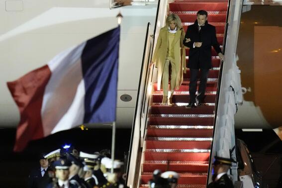 French President Emmanuel Macron with his wife Brigitte Macron arrive at Andrews Air Force Base, Md., on Tuesday, Nov. 29, 2022, for an official state visit. (AP Photo/Manuel Balce Ceneta)