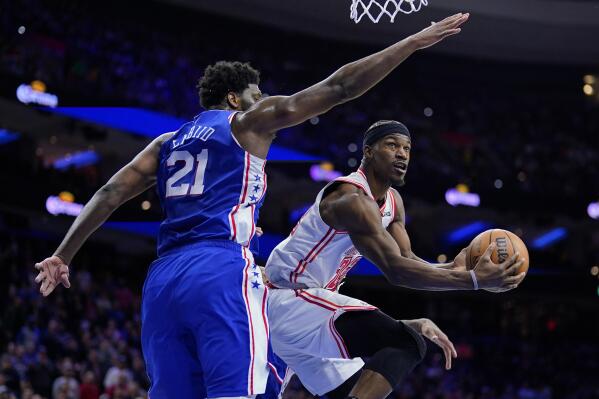Miami Heat's Jimmy Butler, right, goes up for a shot against Philadelphia 76ers' Joel Embiid during the second half of an NBA basketball game, Monday, Feb. 27, 2023, in Philadelphia. (AP Photo/Matt Slocum)