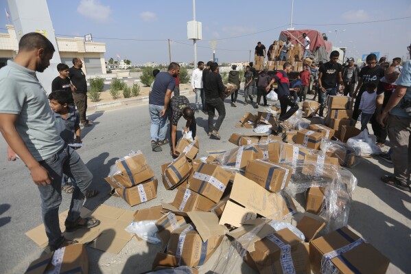 Palestinians loot a truck with humanitarian aid near the Rafah border crossing in the Gaza Strip on Thursday, Nov. 2, 2023. (AP Photo/Hatem Ali)