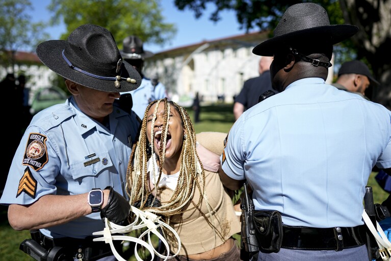 Georgia State Patrol officers arrest a protester on the Emory University campus during a pro-Palestinian demonstration, Thursday, April 25, 2024, in Atlanta.  (AP Photo/Mike Stewart)