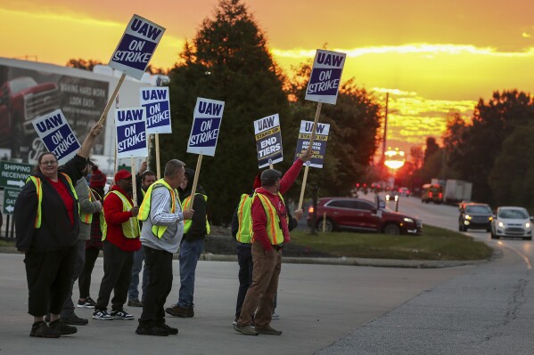 File - UAW local 862 members strike outside of Ford's Kentucky Truck Plant in Louisville, Ky. on Oct. 12, 2023. In each new contract between the United Auto Workers union and General Motors, Ford and Stellantis, parts of the companies' secret long-term plans for new vehicles are exposed. (Michael Clevenger/Courier Journal via AP, File)