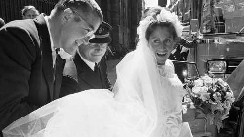 FILE - Peter O'Malley, president of the Los Angeles Dodgers, helps his bride, Annette Zacho, into a car following their wedding in Copenhagen, Denmark, July 10, 1971. Annette O’Malley, who helped her husband promote baseball globally during his family’s ownership of the Dodgers, has died Wednesday, July 19, 2023, in Los Angeles, the Dodgers announced Thursday. She was 81. (AP Photo, File)