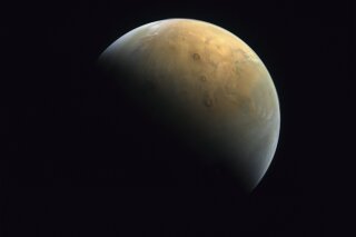 This Feb. 10, 2021 image taken by the United Arab Emirates' "Amal," or "Hope," probe was released Sunday, Feb. 14, 2021, shows Mars . The Hope space probe now circles the red planet. (Mohammed bin Rashid Space Center/UAE Space Agency, via AP)