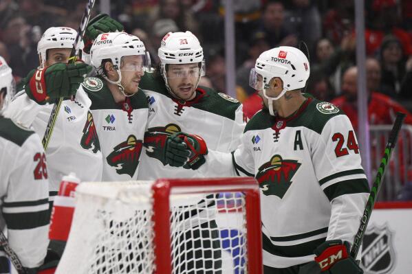 Minnesota Wild defenseman Jonas Brodin, third from right, celebrates his goal with defenseman Matt Dumba (24), right wing Brandon Duhaime (21) and right wing Ryan Reaves, left, during the second period of an NHL hockey game against the Washington Capitals, Tuesday, Jan. 17, 2023, in Washington. (AP Photo/Nick Wass)
