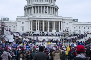 Supporters of President Donald Trump rally outside the U.S. Capitol on Wednesday, Jan. 6, 2021, in Washington. Social media users — including members of Congress — are falsely claiming that newly released footage from that day shows an undercover federal agent flashing his badge. (AP Photo/Jose Luis Magana)