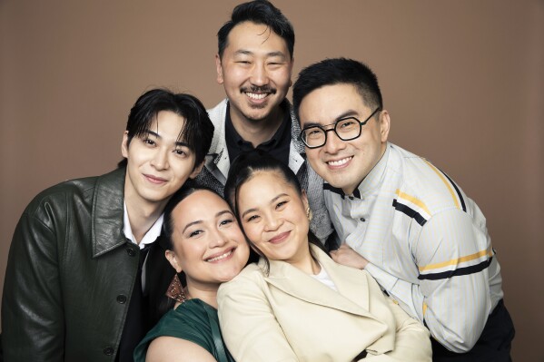 Han Gi-Chan, counterclockwise from left, Lily Gladstone, Kelly Marie Tran, Bowen Yang and Andrew Ahn pose for a portrait to promote "The Wedding Banquet" on Tuesday, April 15, 2025, in West Hollywood, Calif. (Photo by Rebecca Cabage/Invision/AP)