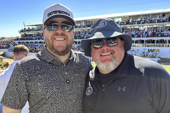 In this image provided by Jeremy Malone, Jeremy Malone, left, and Judson Dymond, the co-owners of The Sportsbook Bar & Grill in Greenwood, Colo., pose for a photot. An arsonist burned down the bar in January. Both co-owners have a parlay they created before the fire that will pay off nearly $600,000 if the Edmonton Oilers win the Stanley Cup Final and help pay for improvements. (Jeremy Malone via AP)