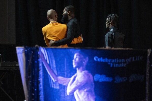 Otis Pena, left, a friend of O'Shae Sibley, walks off stage after speaking during a celebration of life for Sibley on Tuesday, Aug. 8, 2023, at The Met Philadelphia, in Philadelphia. Friends and family members gathered Tuesday to remember Sibley, who was fatally stabbed after he confronted teenagers who taunted his group of gay, Black friends as they danced at a New York City gas station. (AP Photo/Joe Lamberti)