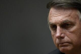 Brazil's President Jair Bolsonaro attends a speech at the Ministry of Economy, in Brasilia, Brazil, Friday, Oct. 22, 2021. (AP Photo/Eraldo Peres)