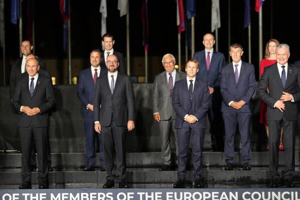 Front row left, to right, Slovenia's Prime Minister Janez Jansa, European Council President Charles Michel, French President Emmanuel Macron and Lithuania's President Gitanas Nauseda pose with other EU leaders during a group photo at an EU summit, at the Brdo Castle in Kranj, Slovenia, Tuesday, Oct. 5, 2021. EU leaders are meeting Tuesday evening to discuss increasingly tense relations with China and the security implications of the chaotic U.S.-led exit from Afghanistan, before taking part in a summit with Balkans leaders on Wednesday. (AP Photo/Darko Bandic)