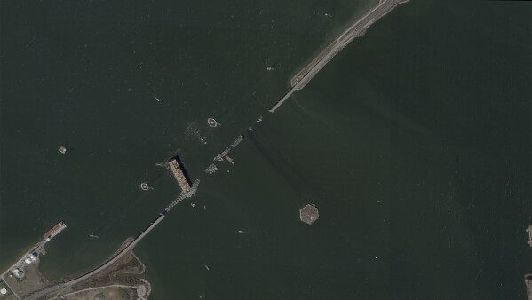 This satellite image provided by Planet Labs shows the container ship Dali lodged against the wreckage of the Francis Scott Key Bridge, Friday, March 29, 2024, in Baltimore, Md. (Planet Labs via AP)