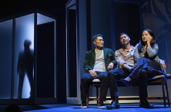 This image released by Polk & Co. shows Daniel Dae Kim, from left, and Ryan Eggold, and Shannon Tyo during a performance of "Yellow Face on Broadway," a play by David Henry Hwang, in New York. (Joan Marcus/Polk & Co. via AP)