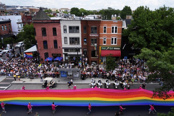 People carry a large pride flag during the World Pride parade, Saturday, June 7, 2025, in Washington. (AP Photo/Julia Demaree Nikhinson)