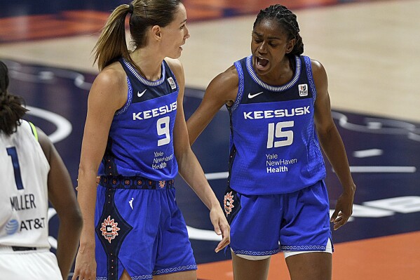 Connecticut Sun's Tiffany Hayes (15) and Rebecca Allen (9) celebrate a foul during a WNBA basketball game against the Minnesota Lynx on Tuesday, Aug. 1, 2023 at Mohegan Sun Arena in Uncasville, Conn. (Sarah Gordon/The Day via AP)