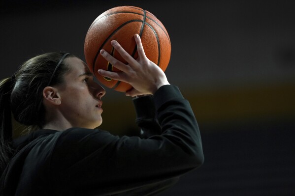 Iowa guard Caitlin Clark warms up before an NCAA college basketball game against Minnesota, Wednesday, Feb. 28, 2024, in Minneapolis. (AP Photo/Abbie Parr)