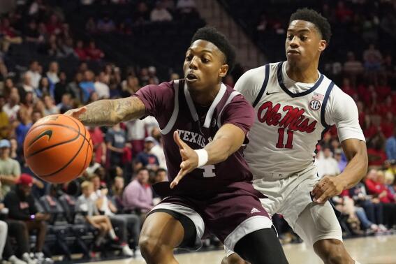 Texas A&M guard Wade Taylor IV (4) reaches for a loose ball while Mississippi guard Matthew Murrell (11) defends during the first half of an NCAA college basketball game in Oxford, Miss., Tuesday, Feb. 28, 2023. (AP Photo/Rogelio V. Solis)