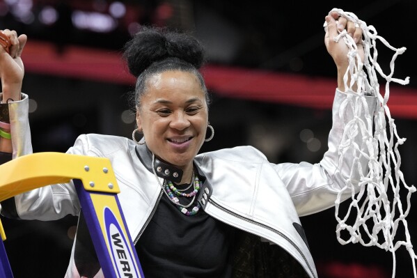 South Carolina head coach Dawn Staley cuts down the net after the Final Four college basketball championship game against Iowa in the women's NCAA Tournament, Sunday, April 7, 2024, in Cleveland. South Carolina won 87-75. (AP Photo/Morry Gash)
