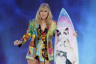 FILE - In this Aug. 11, 2019 file photo, Taylor Swift accepts the Icon award at the Teen Choice Awards  in Hermosa Beach, Calif. Swift plans to re-record her songs after her catalog was purchased by popular music manager Scooter Braun. (Photo by Danny Moloshok/Invision/AP, File)