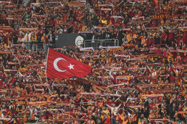 Galatasaray fans cheer during a Turkish Super Lig soccer match between Galatasaray and Fenerbahce in Istanbul, Turkey, Sunday, May 19, 2024. (AP Photo)