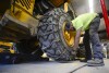 Andy Brown, a highway equipment operator for the Brattleboro, Vt., Public Works Department, puts chains onto a vehicle on Friday, Jan. 5, 2024, in anticipation of this weekend's snow storm. (Kristopher Radder /The Brattleboro Reformer via AP)