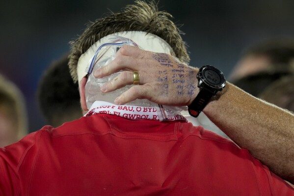 A team assistance places ice on Wales' Aaron Wainwright's head during the Rugby World Cup Pool C match between Wales and Fiji at the Stade de Bordeaux in Bordeaux, France, Sunday, Sept. 10, 2023. (AP Photo/Themba Hadebe)