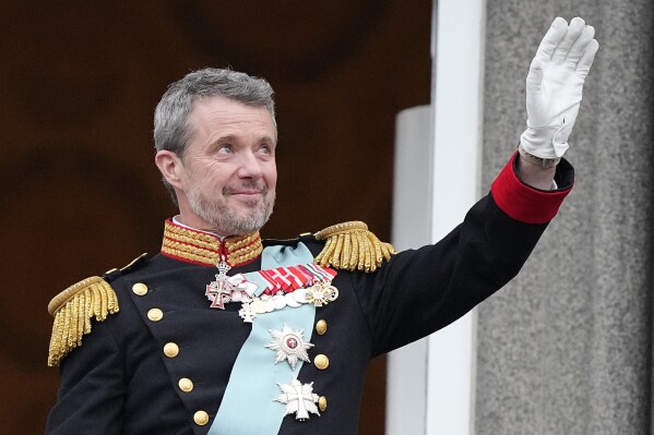 Denmark's King Frederik X waves from the balcony of Christiansborg Palace in Copenhagen, Denmark, Sunday, Jan. 14, 2024. Queen Margrethe II has become Denmark's first monarch to abdicate in nearly 900 years when she handed over the throne to her son, who has become King Frederik X. (AP Photo/Martin Meissner)