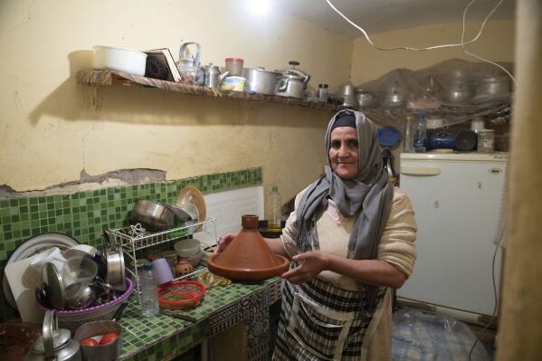 Fatima Barri, 57, prepares food to break her Ramadan fast in her home which was damaged by the earthquake last year, in Amizmiz, near Marrakech, Thursday, April 4, 2024. (AP Photo)
