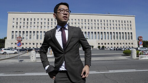 FILE - Hong Kong activist Nathan Law takes part in a protest during a meeting of Chinese Foreign Minister Wang Yi with Italian Foreign Minister Luigi Di Maio, in Rome, Tuesday, Aug. 25, 2020. Hong Kong police on Monday, July 3, 2023, accused eight self-exiled pro-democracy activists, including Nathan Law, of violating the territory's tough National Security Law and offered rewards of 1 million Hong Kong dollars ($127,600) each for information leading to their arrests. (AP Photo/Andrew Medichini, File)