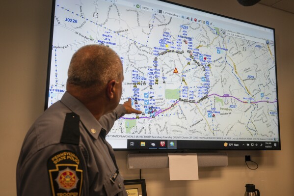 Lt. Col George Vivens shows th map of the area delineated by law enforcement and their vehicles, during a media tour, at the Incident Command Center Where Pennsylvania State Troopers, U.S. Border Patrol, Chester County Emergency Management, and FBI are collaborating on the intergovernmental manhunt searching for escaped inmate Danilo Cavalcante, at the Po-Mar-Lin Fire Company, in Unionville, Pa., Friday, Sept. 8, 2023. (Jessica Griffin/The Philadelphia Inquirer via AP)
