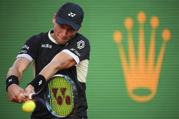 Casper Ruud, of Norway, returns the ball to Serbia's Novak Djokovic during a semifinals match at the Monte Carlo Tennis Masters tournament in Monaco, Saturday, April 13, 2024. (AP Photo/Daniel Cole)