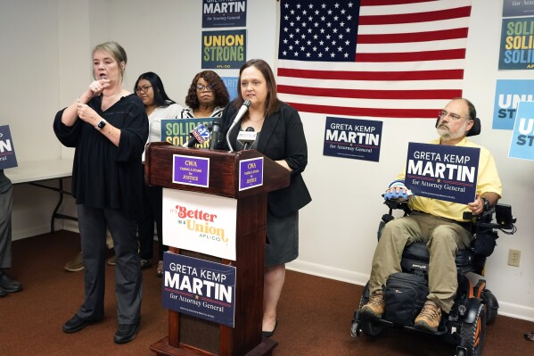Greta Kemp Martin, the Democratic nominee for Mississippi attorney general, at podium, discusses her proposal to create a fair labor division as part of the attorney general's office during a Thursday, Aug. 31, 2023, news conference in Jackson, Miss. (AP Photo/Rogelio V. Solis)