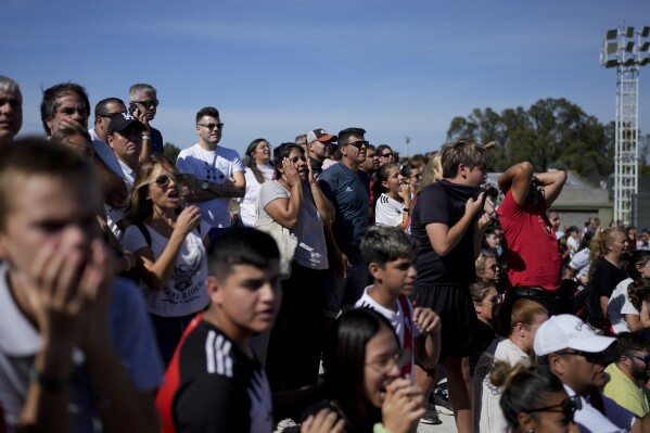 Fans watch a women's professional soccer match between River Plate and Boca Juniors in Ezeiza on the outskirts of Buenos Aires, Argentina, Sunday, March 10, 2024. A growing group of foreigners are joining the Argentinian league as it seeks to boost its recently turned professional women's soccer teams. (AP Photo/Natacha Pisarenko)