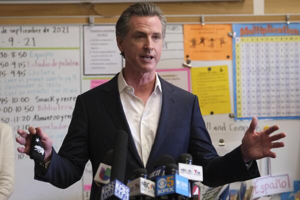 Gov. Gavin Newsom speaks to the press after visiting with students at Melrose Leadership Academy, a TK-8 school in Oakland, Calif., on Wednesday, Sept. 15, 2021, one day after defeating a Republican-led recall effort. (AP Photo/Nick Otto)