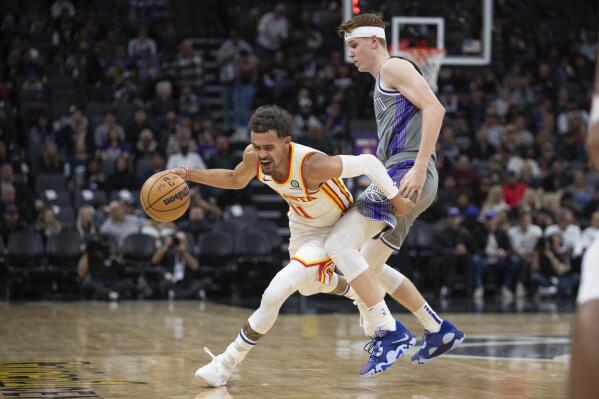 Atlanta Hawks guard Trae Young (11) is fouled by Sacramento Kings guard Kevin Huerter during the second half in an NBA basketball game in Sacramento, Calif., Wednesday, Jan. 4, 2023. (AP Photo/José Luis Villegas)
