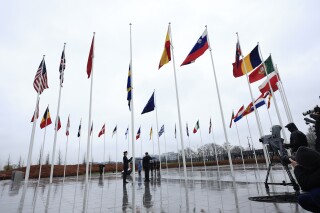 FILE - Members of the military raise the flag of Sweden, as other other alliance member flags flap in the wind, during a ceremony to mark the accession of Sweden to NATO at NATO headquarters in Brussels, Monday, March 11, 2024. Argentina on Thursday, April 18, 2024, requested to join NATO as a global partner, a status that would clear the way for greater political and security cooperation at a time when the right-wing government aims to boost ties with Western powers and attract investment. (AP Photo/Geert Vanden Wijngaert, File)