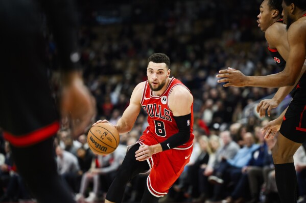 Chicago Bulls guard Zach LaVine (8) drives towards the basket during the first half of the team's NBA basketball game against the Toronto Raptors on Thursday, Jan. 18, 2024, in Toronto. (Christopher Katsarov/The Canadian Press via AP)