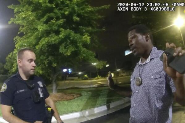 FILE - In this June 12, 2020, file photo from a screen grab taken from body camera video provided by the Atlanta Police Department Rayshard Brooks, right, speaks with Officer Garrett Rolfe, left, in the parking lot of a Wendy's restaurant, in Atlanta. Former Atlanta Police Officer, Rolfe's attorney said Thursday, April 22, 2021, that his client didn't get a chance to defend himself before he was fired for fatally shooting Brooks, a Black man who had been running away from two white officers after he resisted arrest and fired a stun gun at one of them. (Atlanta Police Department via AP, File)