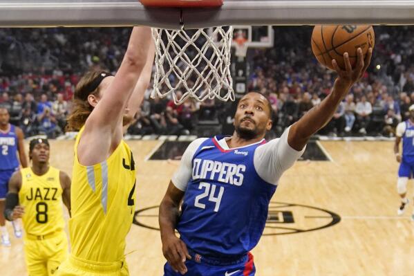 Los Angeles Clippers forward Norman Powell, right, shoots as Utah Jazz forward Kelly Olynyk defends during the first half of an NBA basketball game Monday, Nov. 21, 2022, in Los Angeles. (AP Photo/Mark J. Terrill)