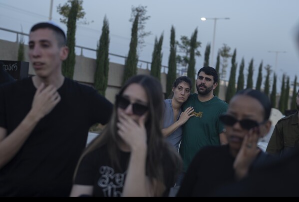 Mourners attend the funeral of the Israeli man Sagiv Ben Svi, killed by Hamas militants while attending a music festival, at a cemetery in Holon, central Israel, Thursday, Oct. 26, 2023. More than 1,400 people were killed and over 200 taken captive in an multi-front attack by the militant group that rules Gaza on Oct. 7.(AP Photo/Petros Giannakouris)