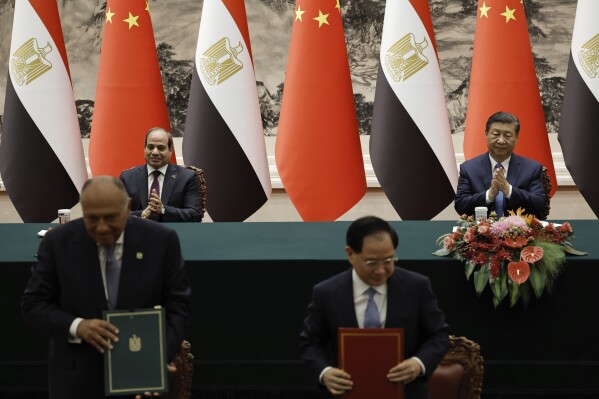 Chinese President Xi Jinping and Egyptian President Abdel Fattah el-Sissi, rear left, attend a signing ceremony at the Great Hall of the People in Beijing, China, Wednesday May 29, 2024. (Tingshu Wang/Pool Photo via AP)