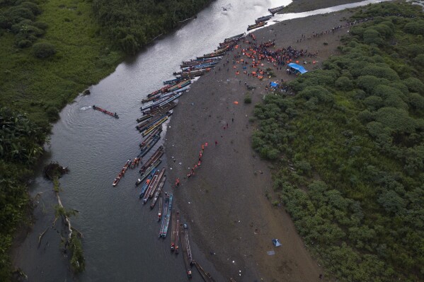 Migrants heading north take boats in Bajo Chiquito in the Darien province of Panama, Thursday, Oct. 5, 2023, after walking across the Darien Gap from Colombia. (AP Photo/Arnulfo Franco)