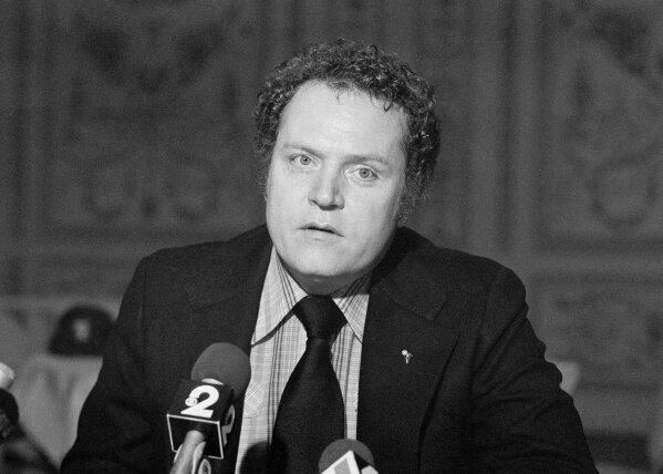 FILE - "Hustler" magazine publisher Larry Flynt reads his Christmas statement to the press on Dec. 18, 1977, in New York. Flynt, who turned "Hustler" magazine into an adult entertainment empire while championing First Amendment rights, has died at age 78. His nephew, Jimmy Flynt Jr., told The Associated Press that Flynt died Wednesday, Feb. 10, 2021, of heart failure at his Hollywood Hills home in Los Angeles. (AP Photo/ Suzanne Vlamis, File)