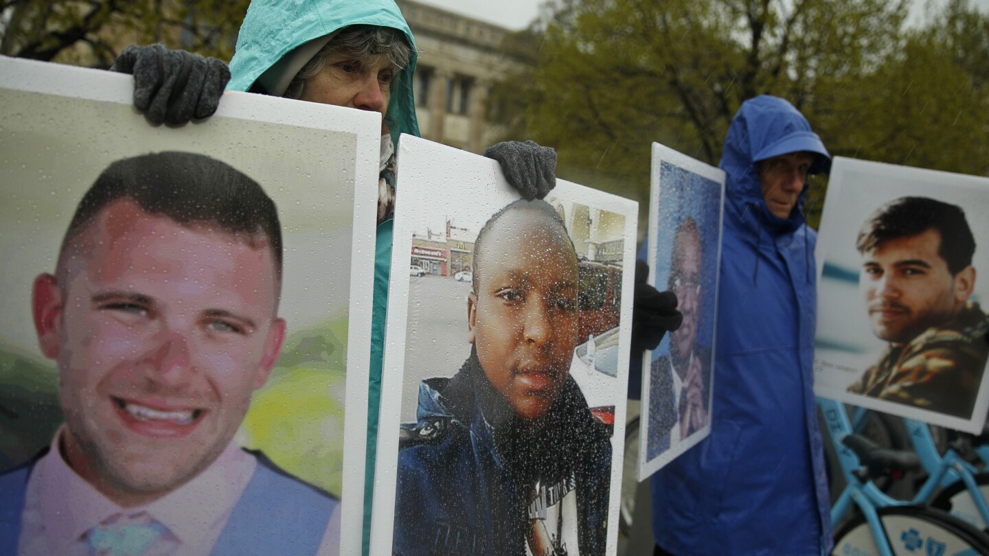 FILE - Protesters hold the photographs of victims, including Melvin Riffel, left, of the Ethiopian Airlines plane crash, outside Boeing’s annual sha